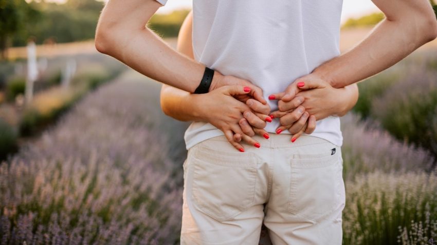 a person standing in a field with their hands on their hips